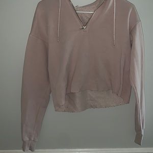 Pale pink hooded, cropped sweater.